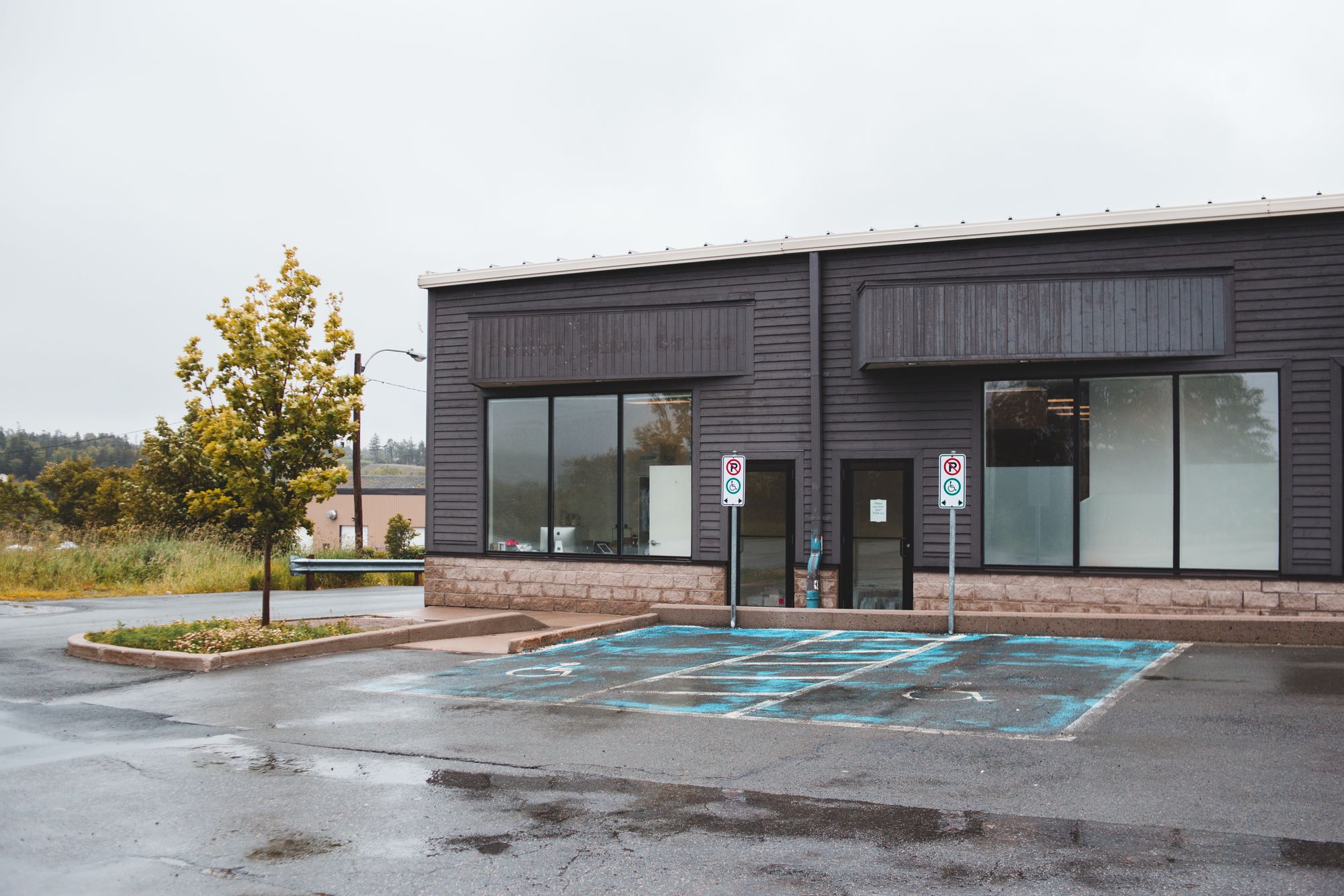 Illustrative stock photograph of a single-story office building and parking area